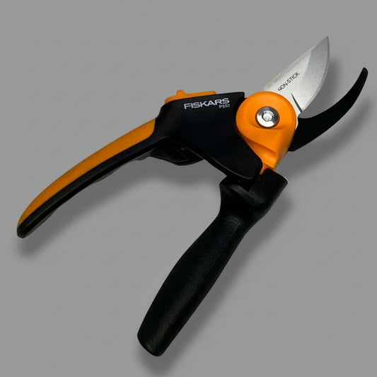 Fiskars pruner on a metallic surface