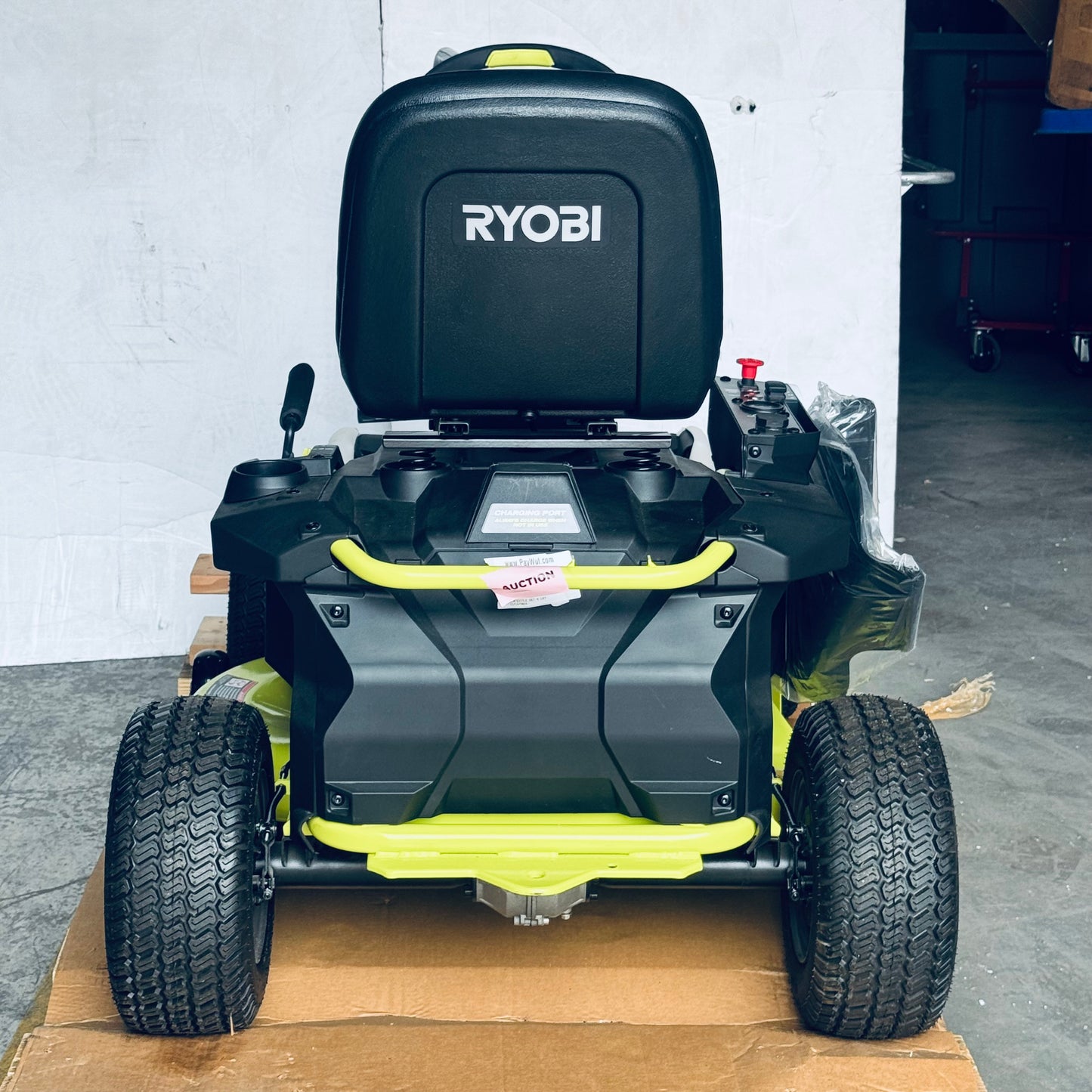 ZA@ RYOBI RYOBI 48V Brushless 38 in. 100 Ah Battery Electric Rear Engine Riding Lawn Mower Sz 64”Lx44”Hx41”W, Green & Black Color (AS-IS, Dinged Steering Wheel)