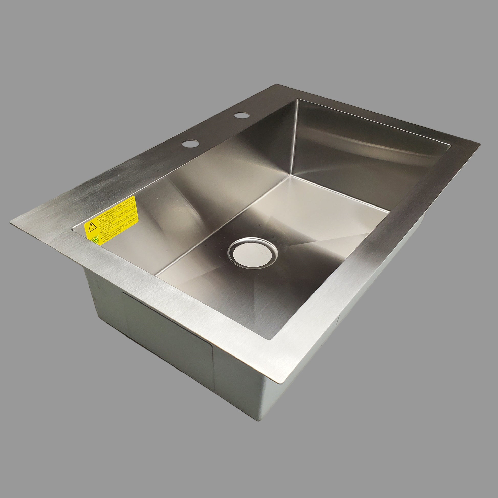 Stainless steel kitchen sink on a gray countertop